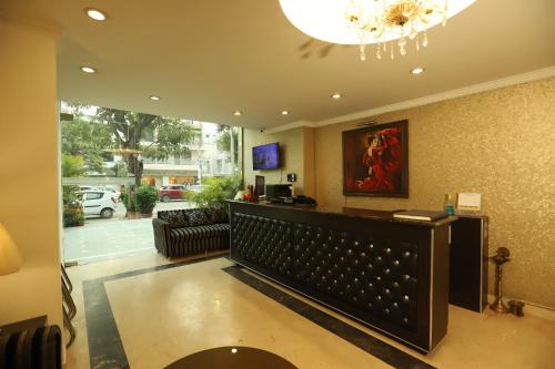 a lobby with a hair salon with a chandelier at Hotel Capitol Hills - Greater Kailash Delhi in New Delhi