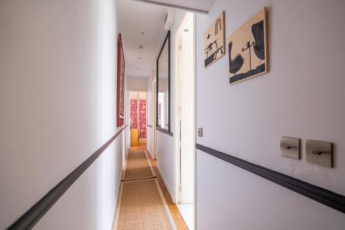 a hallway of a home with white walls at Veeve - Impressions of the Eiffel Tower in Paris