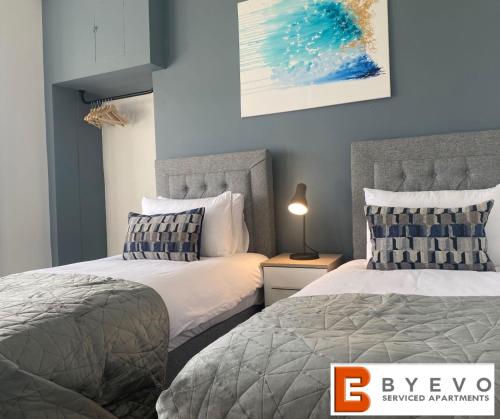 two beds sitting next to each other in a bedroom at ByEvo 19 Walker - perfect for contractors - close to GLA in Paisley