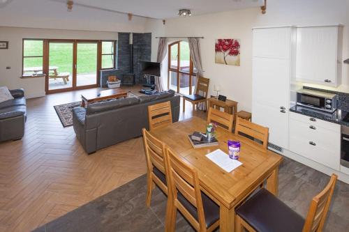 a living room with a table and a couch at Laurel Cottage at Williamscraig Holiday Cottages in Linlithgow
