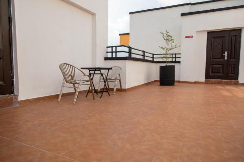 a patio with a table and chairs in a building at Executive Large Room with Ensuite in Accra