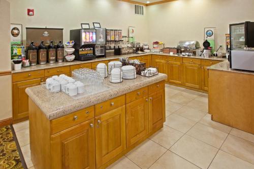 a kitchen with a counter with cups and plates on it at Country Inn & Suites by Radisson, Columbus West, OH in Columbus