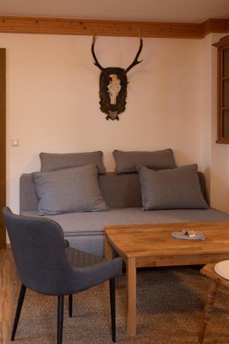 a living room with a couch and a table at Appartements Kirchenwirt in Kirchberg in Tirol