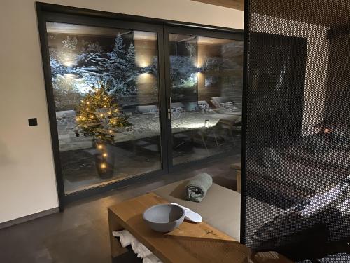 a living room with a christmas tree in a window at Vista Resort & Club in Prague