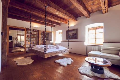 a living room with a large bed and a couch at Mill Apartments in Český Krumlov