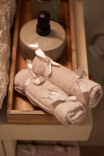 a couple of towels on a wooden tray at Dandy Villas Dimitsana - a family ideal charming home in a quaint historic neighborhood - 2 fireplaces for romantic nights in Dhimitsana