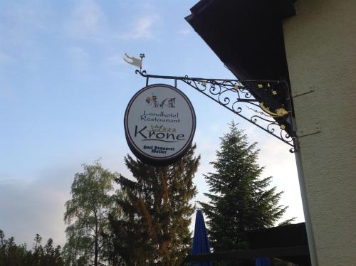 a sign for a karmaarmaarma restaurant on the side of a building at Landhotel Krone in Oberreute