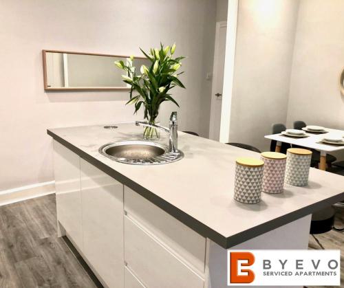 a bathroom with a sink and a mirror at ByEvo Almar Villa - Comfy Contractor or Large groups property in Glasgow