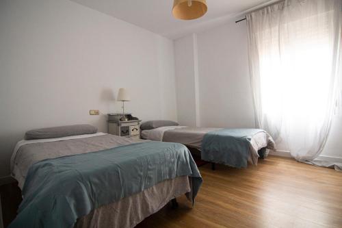 Posteľ alebo postele v izbe v ubytovaní Apartamento Albareda Centro