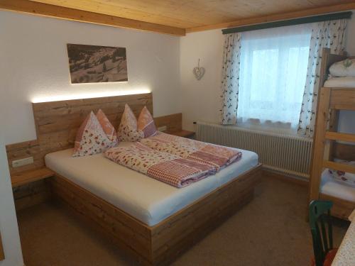 a small bedroom with a bed and a window at Viehhofbauer in Maria Alm am Steinernen Meer