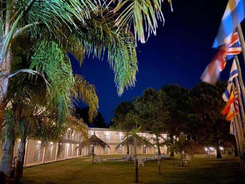 a building with a palm tree in front of it at Hotel Portezuelo in Punta del Este