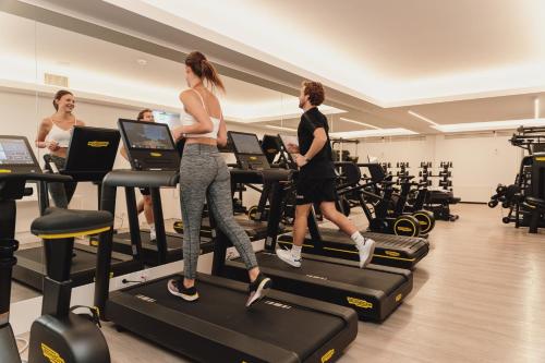 a group of people running on treadles in a gym at Hotel Morfeo in Milan