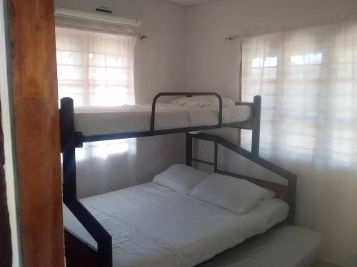 two bunk beds in a room with a window at Cabaa De Descanso, Isla De Bar - Cartagena - Rest Cabin, Baru Island -Bolivar in Playa Blanca