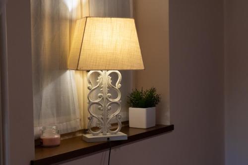 a lamp sitting on a shelf next to a window at Sweet Balcony Charme&Relax in Bergamo