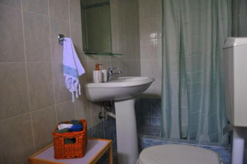 a bathroom with a sink and a toilet and a shower at MagnoliaHouse 1 in Preveza