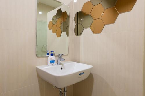 a bathroom with a sink and a mirror at One Bedroom BeachfrontPoolfront Located In Cha-amHua Hin in Cha Am