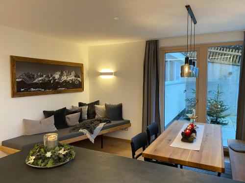 a living room with a couch and a table at s'pölven NEST in Bad Häring