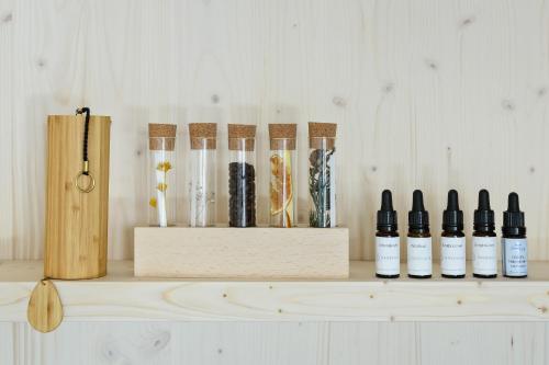 a shelf with five bottles of essential oils on it at Romantik Hotel Schweizerhof & Spa Flims in Flims