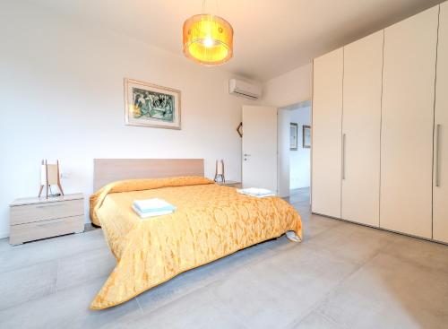 a bedroom with a bed with a orange bedspread at Cà Laguna Lido in Venice-Lido