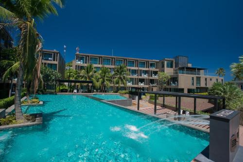 a large swimming pool in front of a building at Pixel - Studio Cape Panwa Ocean Front Partial Seaview in Ban Ao Makham