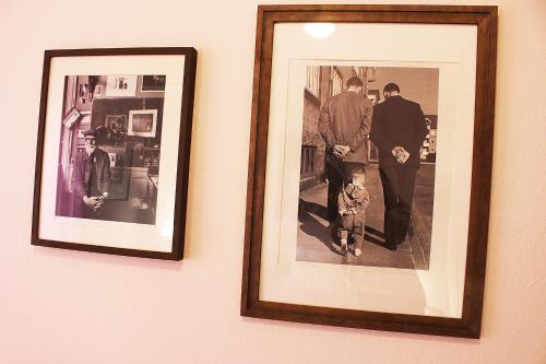 two framed photographs of a man and a child on a wall at Alkinoos Apt -Inspiring Living in Meteora -3BD in Kalabaka