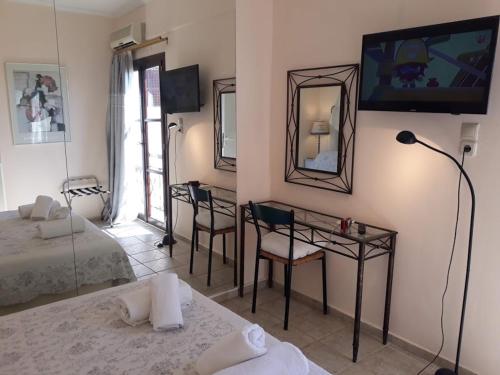 a bedroom with a bed and a desk and a mirror at Calergi Residence - Holidays in Crete in Atsipopoulo