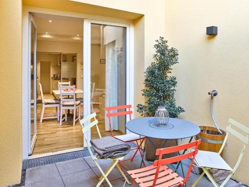 a patio with a table and chairs and a table at Innheaven Apartments in Innsbruck