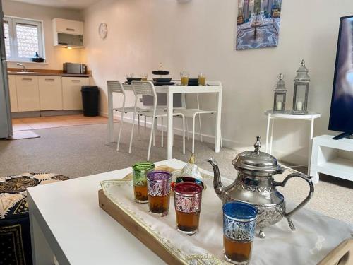 a tray with a tea kettle on a table at Moroccan Inspired Northampton Apartment in Northampton