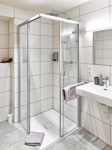 a bathroom with a shower and a sink at Innheaven Apartments in Innsbruck
