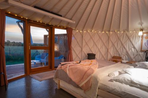 a bedroom with a bed in a yurt at Izera Glamping Adults - Luksusowe jurty&spa (adults only) in Gajowka