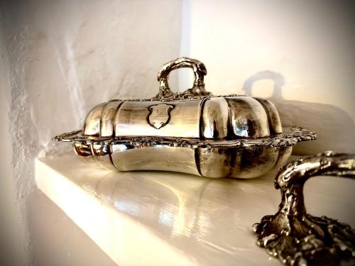a silver purse sitting on top of a sink at The White House at The Tinners Arms in St Ives