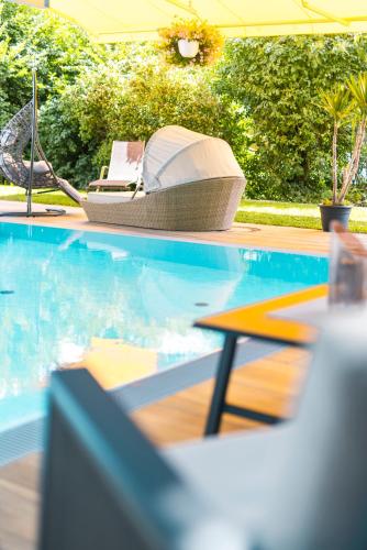 a pool with a chair and a laptop on it at Hotel Moarhof in Lienz