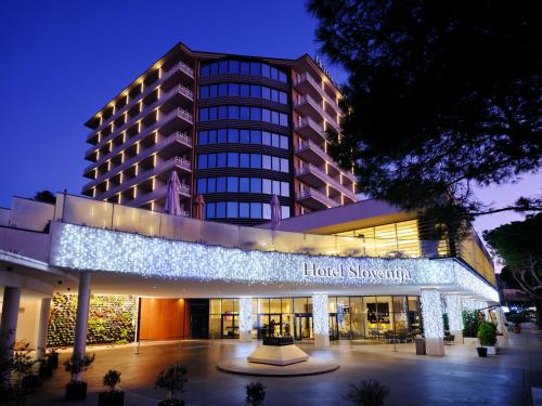 a hotel lobby with a lit up building at night at Hotel Slovenija - Terme & Wellness LifeClass in Portorož