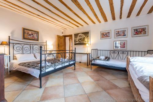 a bedroom with two beds and a ceiling at Luxury Chalet with outdoor Hot Tub, Sauna, Gardens & Mountain Views! in Briançon