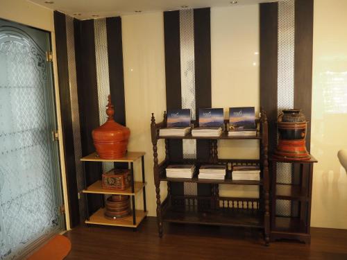 a room with a shelf with books and vases at 7B-Short-term rental allowed-5BRs Downtown Bangkok in Makkasan