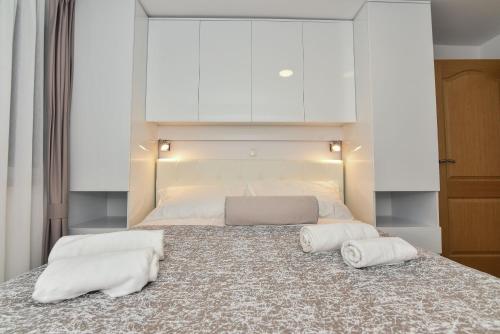 a bedroom with a large bed with two pillows on it at Apartment Sana 1 in Vir