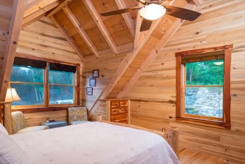 a bedroom with a bed in a log cabin at A Touch of Luxury in Lake Lure