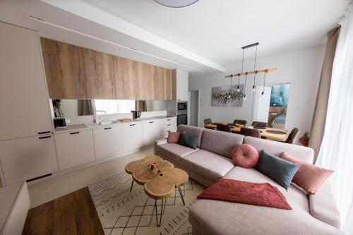 a living room with a couch and a table at Apartmán Snow in Oravská Lesná