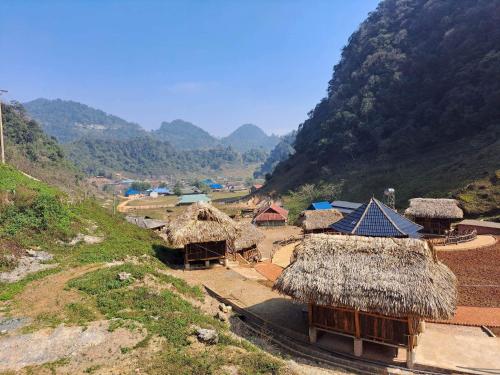 a group of huts on top of a mountain at Homestay Highland Hmong in Hòa Bình
