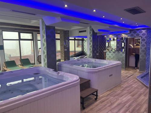 a large bathroom with two hot tubs in it at Apartment Elvir in Kopaonik