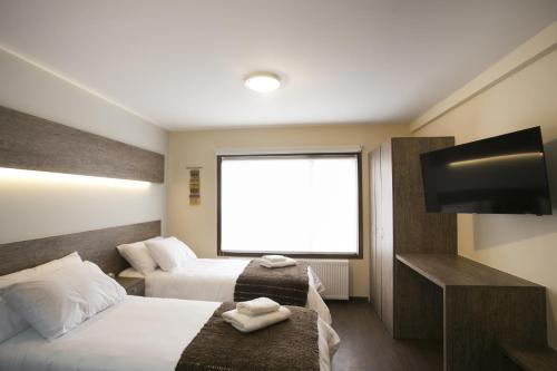 Ein Bett oder Betten in einem Zimmer der Unterkunft Rumbo Sur Apart Hotel