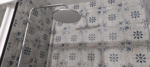 a shower with a shower curtain in a bathroom at Melina's comfort rustic home in Artemida
