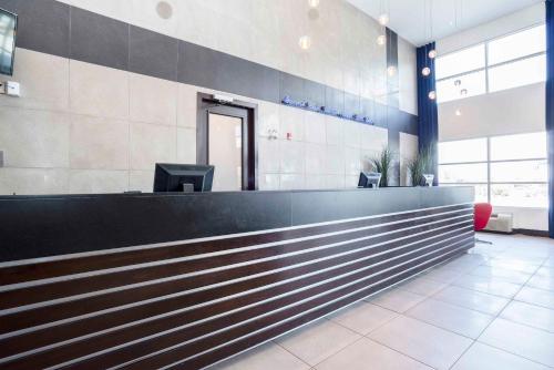 a lobby with a reception desk in a building at Sandman Signature Prince George Hotel in Prince George