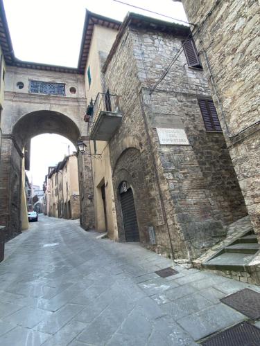 an old stone building with an archway on a street at Vermaaten Boutique Suites Diamond in Todi