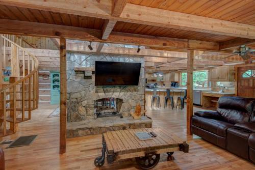 a living room with a stone fireplace in a house at Hidden Creek Cabin in Fleetwood