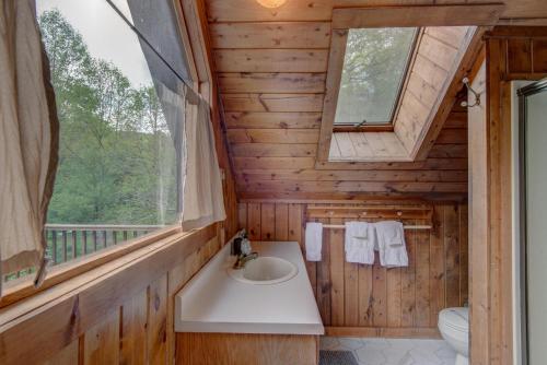a bathroom with a sink and a window at Hidden Creek Cabin in Fleetwood