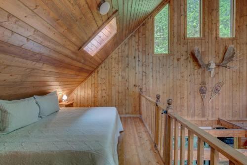 a bedroom with a bed in a wooden cabin at Hidden Creek Cabin in Fleetwood