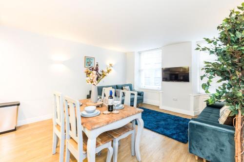 a dining room and living room with a table and chairs at Luxury Modern 3 Bedroom Apartment in City Centre in Edinburgh