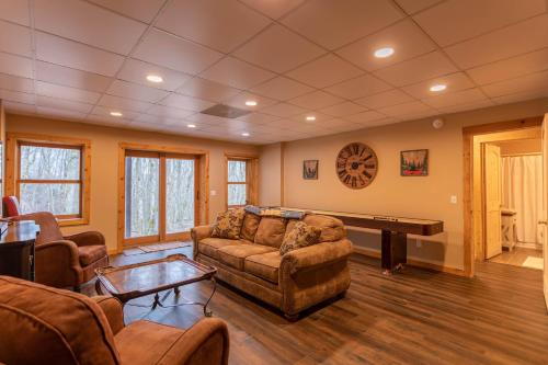a living room with a couch and a piano at The Feisty Fox in Sugar Mountain