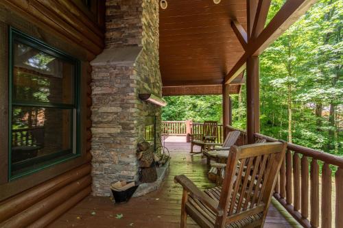 a porch of a house with rocking chairs on it at The Feisty Fox in Sugar Mountain